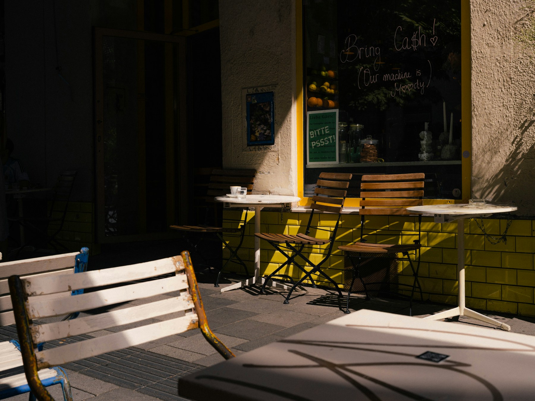 Sunlight falling across tables outside a cafe