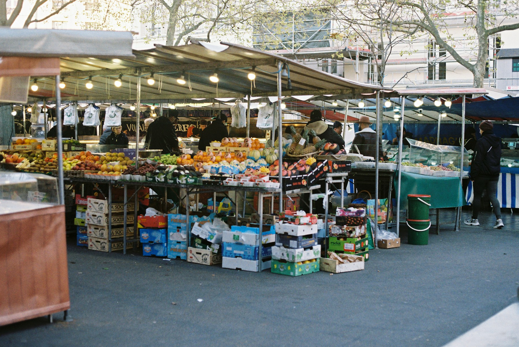 People browsing produce at an outdoor market